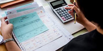 Financial audit with calculator and documents